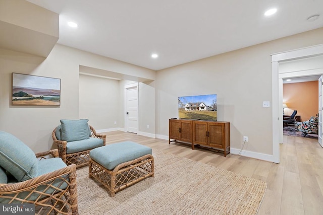 sitting room featuring light wood-style floors, recessed lighting, and baseboards