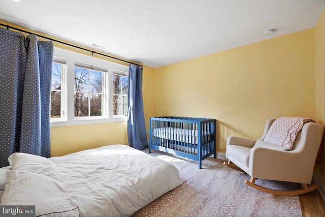 bedroom featuring wood finished floors and baseboards