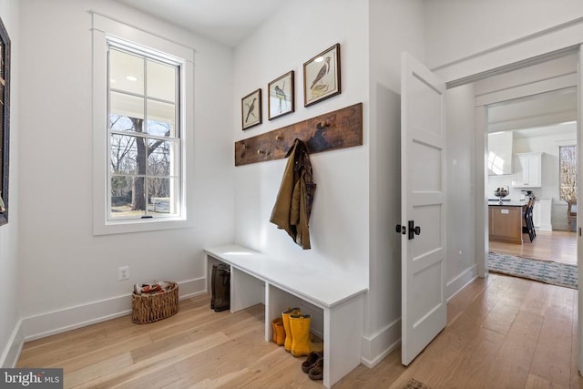 mudroom with light wood-style floors and baseboards