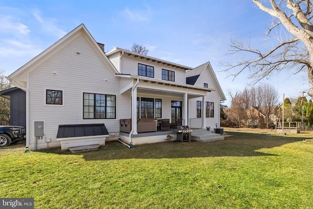 back of property with a porch, a lawn, and cooling unit