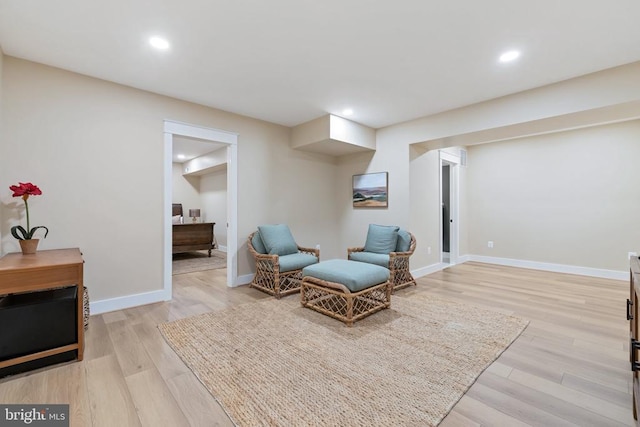 sitting room featuring recessed lighting, baseboards, and light wood finished floors