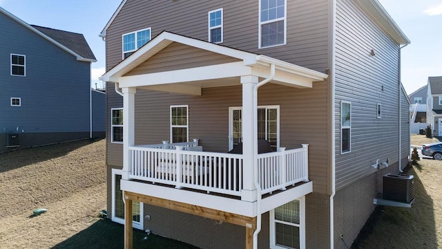 rear view of property with central AC unit