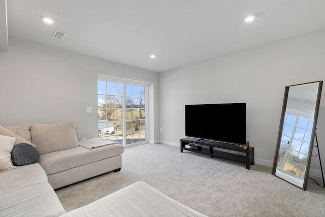 carpeted living area with visible vents, baseboards, and recessed lighting