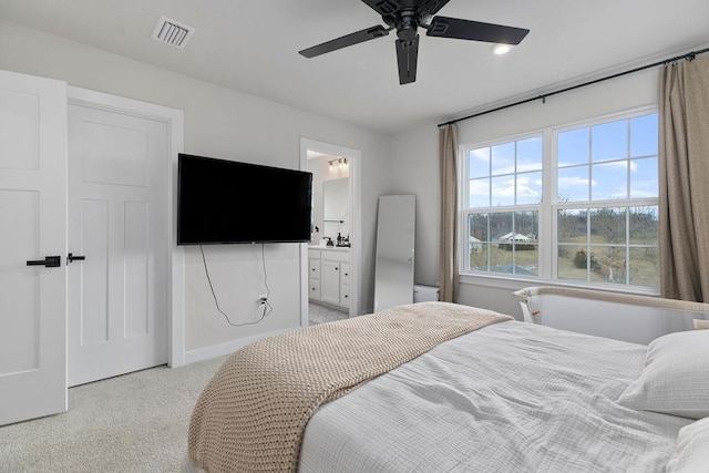 bedroom featuring carpet, visible vents, connected bathroom, ceiling fan, and baseboards