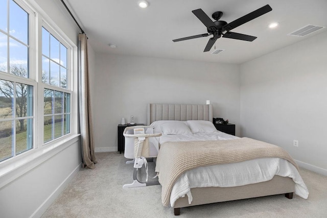 carpeted bedroom with multiple windows, visible vents, and baseboards