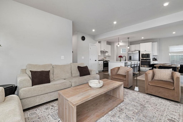 living room with light wood-style floors and recessed lighting