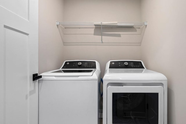 washroom featuring laundry area and washing machine and clothes dryer