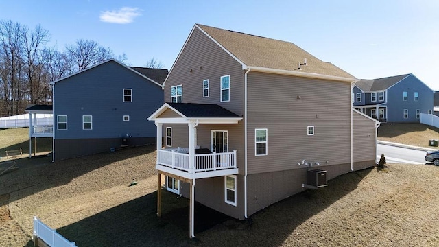 rear view of house with central AC unit and a deck