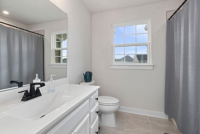 full bathroom with curtained shower, toilet, vanity, tile patterned flooring, and baseboards