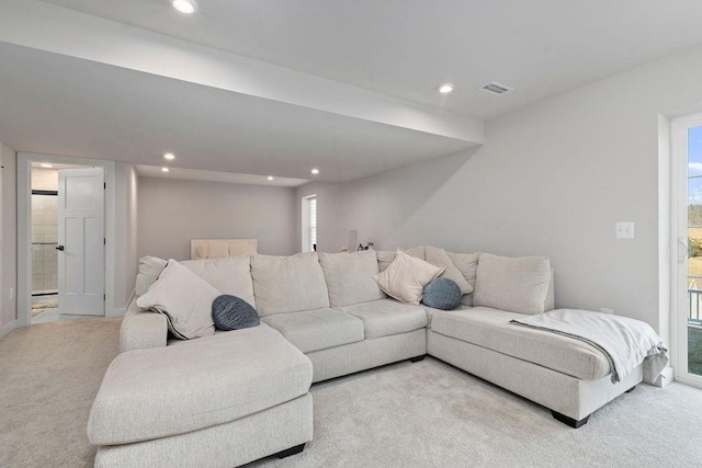 carpeted living area featuring visible vents and recessed lighting