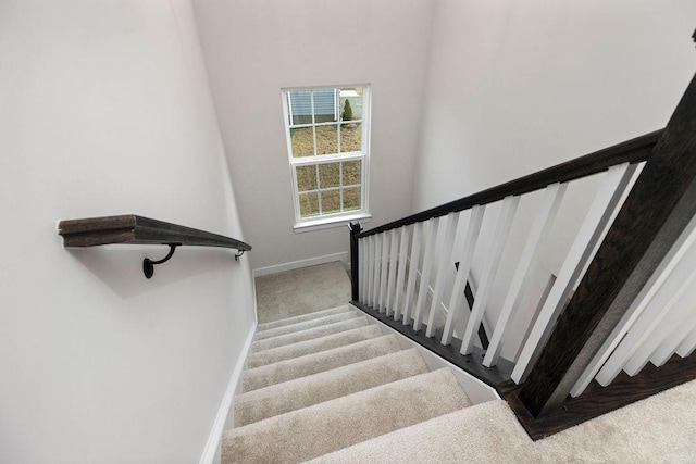 stairs featuring carpet and baseboards