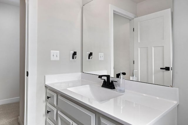 bathroom featuring baseboards and vanity