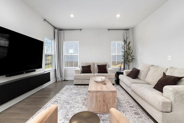 living area featuring recessed lighting, baseboards, and wood finished floors