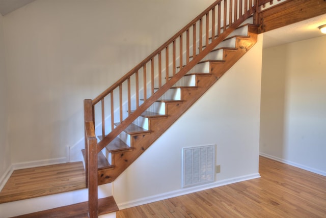 stairway featuring wood-type flooring