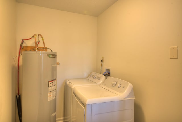 washroom with water heater and washing machine and clothes dryer