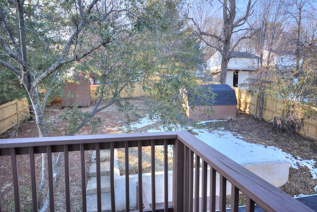 snow covered deck with a storage shed