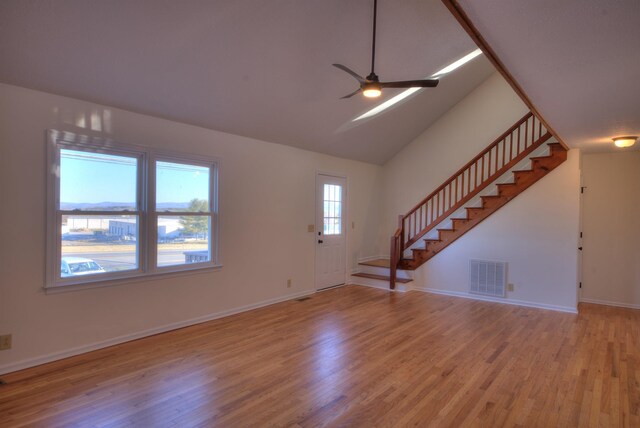 unfurnished living room featuring vaulted ceiling, ceiling fan, and light hardwood / wood-style floors