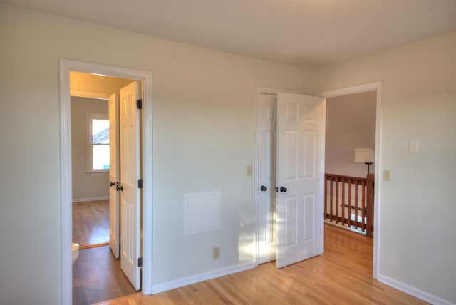 unfurnished bedroom with light hardwood / wood-style floors and a closet