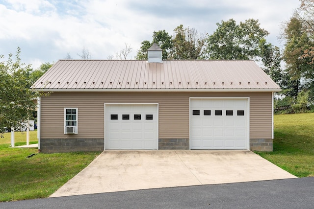 garage featuring a lawn