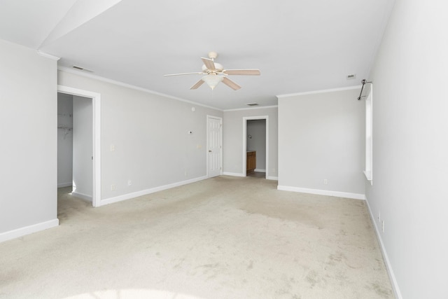 carpeted empty room with crown molding and ceiling fan