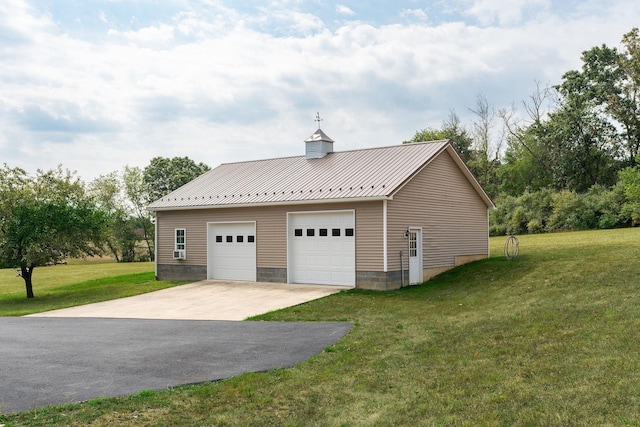 garage featuring a lawn