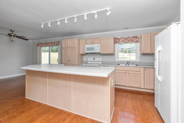 kitchen with light brown cabinetry, sink, light wood-type flooring, a kitchen island, and white appliances