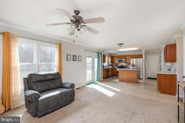 living room with crown molding, light carpet, and ceiling fan