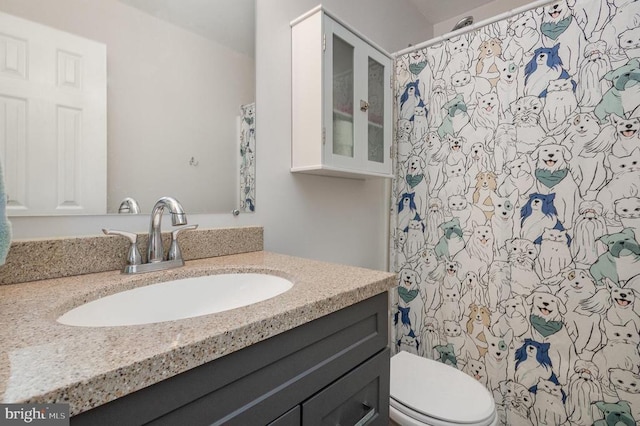 bathroom featuring vanity and toilet