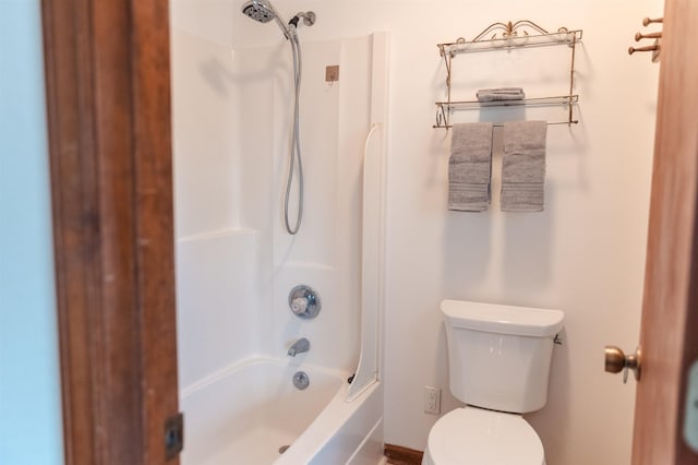 bathroom with shower / bathing tub combination and toilet