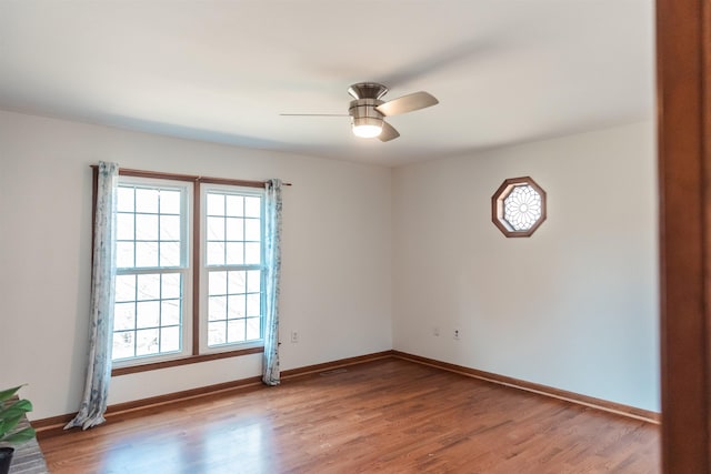 unfurnished room featuring light wood-type flooring, a wealth of natural light, baseboards, and a ceiling fan