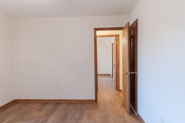 empty room featuring light wood-style flooring and baseboards