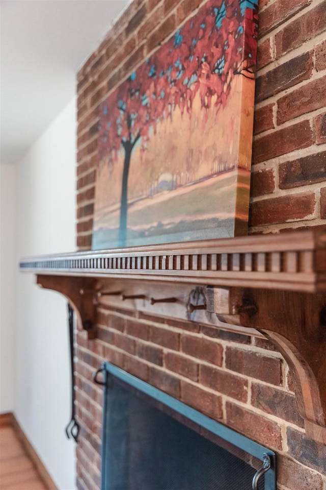 interior details with a brick fireplace and baseboards