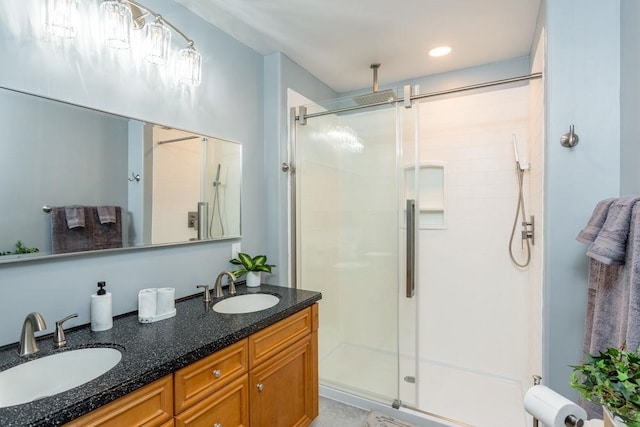 bathroom featuring vanity and a shower with shower door