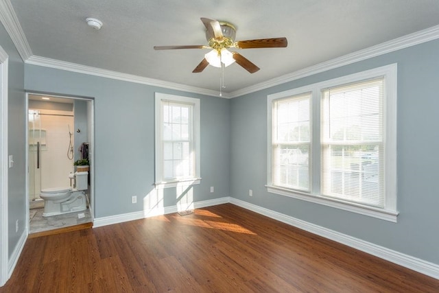 empty room featuring ornamental molding, plenty of natural light, ceiling fan, and dark hardwood / wood-style flooring