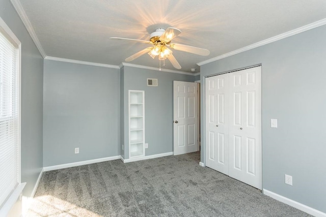 unfurnished bedroom with crown molding, a closet, ceiling fan, and carpet flooring