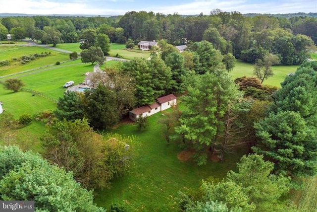 drone / aerial view featuring a wooded view