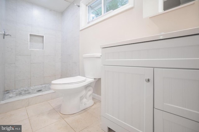 full bath with a stall shower, vanity, toilet, and tile patterned floors