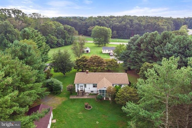 birds eye view of property featuring a wooded view