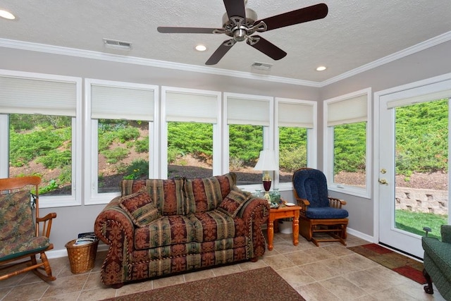 sunroom / solarium featuring visible vents, ornamental molding, a textured ceiling, and baseboards