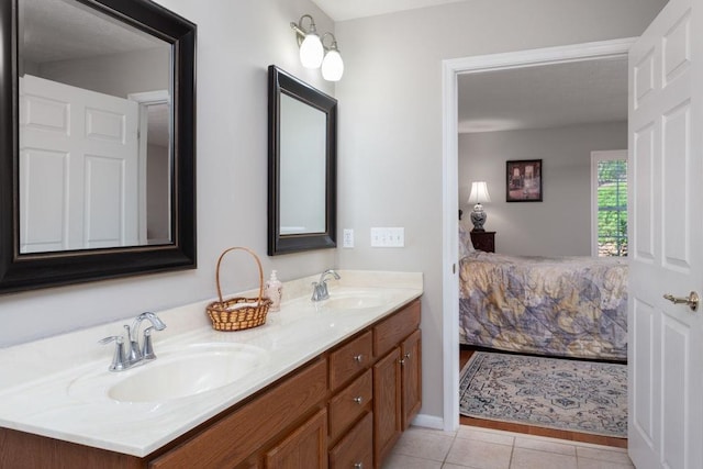 ensuite bathroom featuring a sink, tile patterned floors, ensuite bath, and double vanity