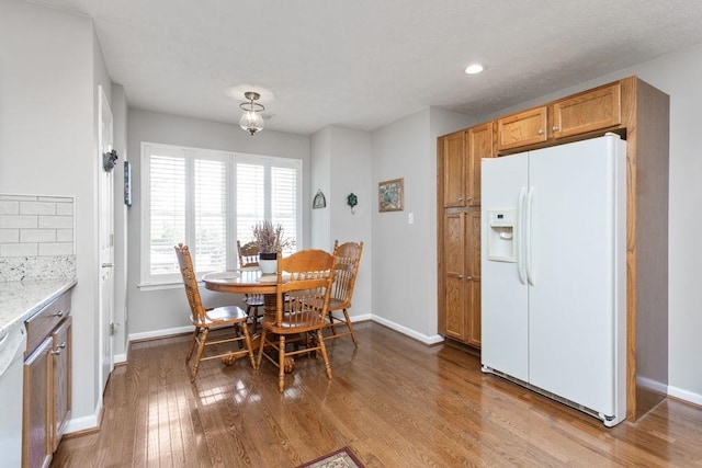 dining area featuring recessed lighting, baseboards, and wood finished floors