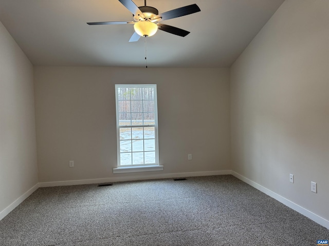 spare room with ceiling fan and carpet