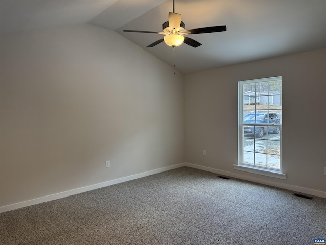 spare room featuring lofted ceiling, carpet floors, and ceiling fan