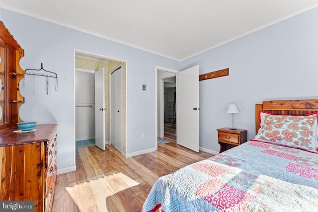 bedroom featuring baseboards, ornamental molding, and light wood-style floors