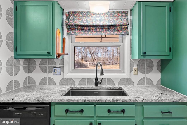 kitchen featuring a sink, light stone countertops, black dishwasher, and green cabinetry