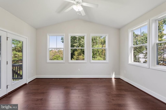 spare room with ceiling fan, vaulted ceiling, baseboards, and dark wood finished floors