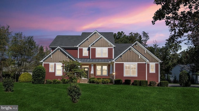 craftsman inspired home featuring board and batten siding, a standing seam roof, metal roof, and a front lawn