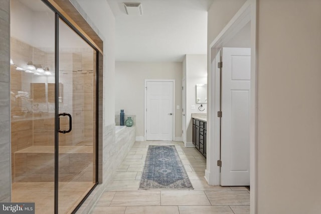 full bath featuring a stall shower, visible vents, a bath, and vanity