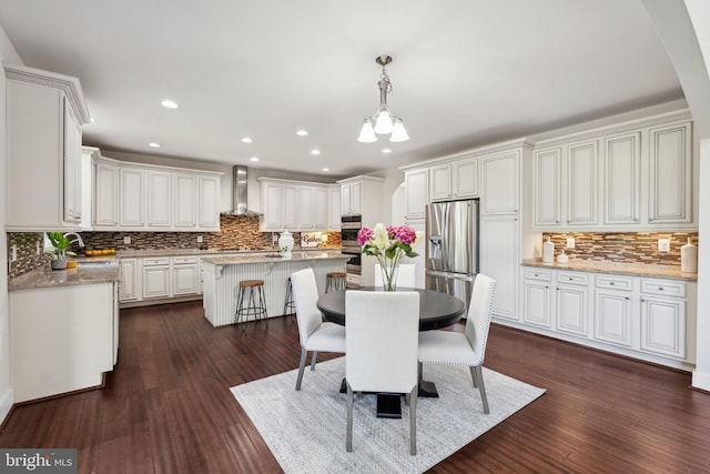 dining area featuring dark wood-style floors, a chandelier, and recessed lighting