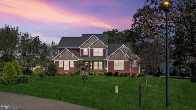 craftsman-style home featuring board and batten siding and a front yard